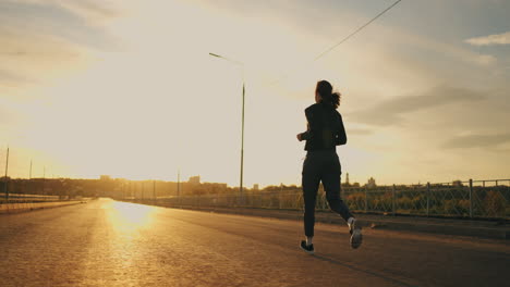 athletic-woman-is-running-outdoors-in-morning-training-in-sunrise-for-keeping-fit-and-good-health